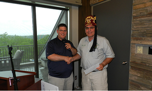 PTAO President Joey Gagne presenting the money raised to Shriners Potentate Dave Rawn. The money went towards the Rameses Shriners Hospital Fund to help kids and fund their operations.